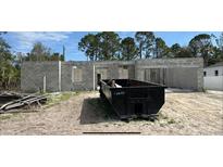 New construction shows cinder block walls, dumpsters and lumber on a sunny day at 2082 Winningway St, Port Charlotte, FL 33948