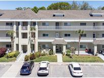 Beautiful condo exterior showcasing well-manicured landscaping and accessible parking at 2210 Utopian E Dr # 314, Clearwater, FL 33763