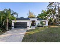 Charming single-story home featuring a well-manicured lawn, covered entry, and attached two-car garage at 2503 Dumont Ln, North Port, FL 34286
