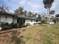 Charming single-story home with well-maintained lawn and landscape and a white exterior at 355 Highland Shores Dr, Ellenton, FL 34222