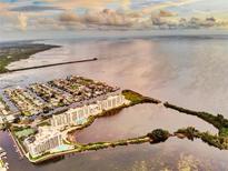 Stunning aerial view of waterfront condos with pools and boat docks near a beautiful coastal waterway at 6009 Sea Ranch Dr # 101, Hudson, FL 34667