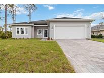 Charming single-story home with a two-car garage, landscaped yard and brick paver driveway at 4160 Belladonna Ave, North Port, FL 34286