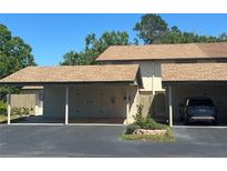 Well-maintained townhouse with a covered parking area, featuring a neutral color palette at 1961 Whitney Way, Clearwater, FL 33760