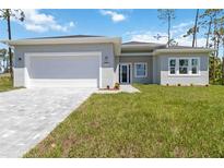 Charming single-story home with a well-manicured lawn and a paved driveway leading to a two-car garage at 4344 Jaslo Ave, North Port, FL 34286