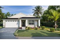 Charming single-story home boasting manicured landscaping, elegant stonework, and a welcoming two-car garage at 487 Sunset N Rd, Rotonda West, FL 33947