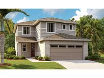 Charming two-story home with neutral siding, stone accents, a two-car garage, and a well-manicured lawn at 6018 Jensen View Ave, Apollo Beach, FL 33572