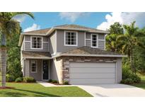 Charming two-story home featuring a two-car garage, stone accents, neutral siding, and well-manicured landscaping at 6034 Jensen View Ave, Apollo Beach, FL 33572