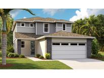 New two-story home featuring modern design, stone accents, neutral color palette, attached two-car garage and manicured front lawn at 6042 Jensen View Ave, Apollo Beach, FL 33572
