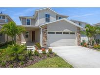 Beautiful two-story home featuring a two-car garage and professionally landscaped front yard at 6046 Jensen View Ave, Apollo Beach, FL 33572