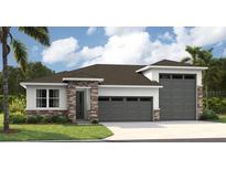 Inviting single-story home with a two-car garage and attractive stone and siding facade, perfect for modern living at 9058 Players Dr, Weeki Wachee, FL 34613