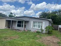Exterior of home with blue sky and landscaped yard, offering a peaceful view at 1009 Kenmore Dr, Brandon, FL 33510