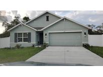 Charming single-story home with a two-car garage, neat landscaping, and a well-maintained front lawn at 6315 Hillview Rd, Spring Hill, FL 34606