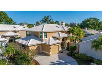 Stunning two-story home featuring a tile roof, dual garage, and mature landscaping at 1103 Kensington Ct, Safety Harbor, FL 34695