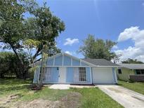 Charming single-story home with light blue exterior, white trim, and an attached one-car garage at 4546 Ontario Dr, New Port Richey, FL 34652