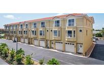 Charming townhome row with attached garages, balconies, and well-maintained exteriors at 1061 Pinellas Bayway S, Tierra Verde, FL 33715