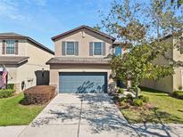 Charming two-story home featuring a two-car garage, well-maintained landscaping, and inviting curb appeal at 4502 Banyan Tree Pl, Riverview, FL 33578
