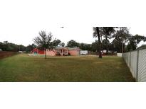 Pink house with a large yard at 1430 N Kingsway Rd, Seffner, FL 33584