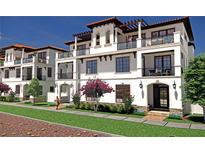Three-story townhouses with balconies, Mediterranean-style architecture, and landscaped grounds at Lot 11 Bayshore Dr, Safety Harbor, FL 34695