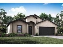 Tan house with a dark brown door and garage door at 5413 Dayton Ln, Port Charlotte, FL 33981