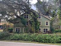 Two-story house with lush landscaping and a large tree in the front yard at 4623 John Moore Rd, Brandon, FL 33511