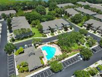 Aerial view of a community featuring townhomes, pool, landscaping, and parking at 2220 Kings Palace Dr, Riverview, FL 33578