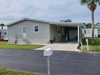 Mobile home with carport and landscaping at 2140 Gondola Dr, Sarasota, FL 34238