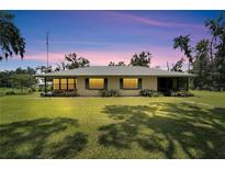Ranch-style home with metal roof and large grassy yard at 3003 N Wilder Rd, Plant City, FL 33563