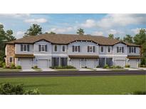 Contemporary townhome community with attached garages and well-manicured lawns at 10439 Lavender Aster Trl, San Antonio, FL 33576