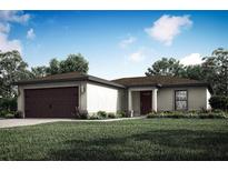 One-story home with dark brown garage door at 13315 Flaherty Ave, Port Charlotte, FL 33981