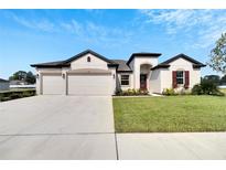 Two-car garage and landscaped yard at 839 Tierra Dr, Spring Hill, FL 34609