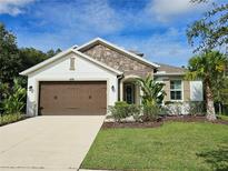 Two-story house with brown garage door and stone accents at 16320 Hyde Manor Dr, Tampa, FL 33647