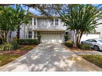 Charming two-story home featuring a well-kept lawn, two-car garage, and neatly trimmed landscaping at 2839 Bayshore Trails Dr, Tampa, FL 33611