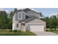 Two-story home with gray siding and white garage door at 11773 Radiant Shore Loop, San Antonio, FL 33576
