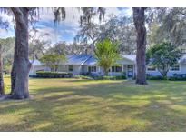 Ranch-style home with a large yard and mature trees at 12945 Morris Bridge Rd, Thonotosassa, FL 33592