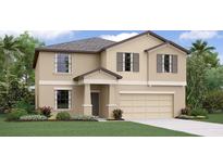 Two-story house with a two-car garage, shutters, and landscaping at 6538 Back Forty Loop, Zephyrhills, FL 33541