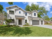 Charming two-story home with a three-car garage, manicured lawn and tasteful landscaping at 4005 W San Rafael St, Tampa, FL 33629