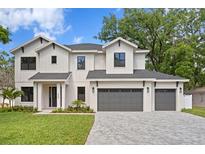 Beautiful two story home with three car garage, lovely landscaping, and modern design at 4005 W San Rafael St, Tampa, FL 33629