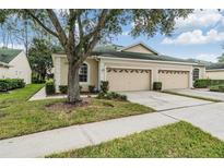 Beautiful two-car garage villa with lush landscaping at 34841 Double Eagle Ct, Zephyrhills, FL 33541