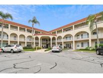 Two-story building exterior with parking and palm trees at 2433 Brazilia Dr # 43, Clearwater, FL 33763
