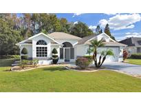 Single-story home with landscaped lawn and two-car garage at 1707 Tremont Ct, Sun City Center, FL 33573