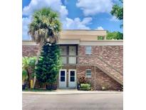 Brick building with two entrances and a stairway at 10423 Carrollbrook Cir # 201, Tampa, FL 33618