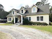 Two story home with covered porch and landscaping at 8529 Kenton Rd, Wesley Chapel, FL 33545