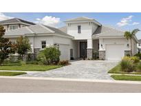Beautiful single-Gathering home with a well-manicured lawn and two-car garage, showing great curb appeal at 17721 Roost Pl, Lakewood Ranch, FL 34211