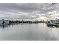 Scenic waterfront view showcasing the tranquil canal lined with homes and docked boats under a cloudy sky at 12246 2Nd E St # 503, Treasure Island, FL 33706