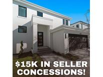 Modern two-story home showcasing a black garage door and an inviting front entrance at 2355 Bahia Vista St, Sarasota, FL 34239