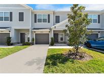 Modern two-story townhouse with gray siding and landscaping at 9658 Sweetwell Pl, Riverview, FL 33569