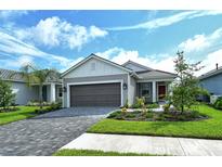 One-story house with gray siding, gray garage door, and a red front door at 2592 Dasheen Pl, Sarasota, FL 34240