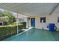 Front view of single story home with carport and landscaped yard at 604 Park Cir # 16, Bradenton, FL 34207