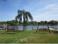 Peaceful waterfront view with two park benches at 2424 W Tampa Bay Blvd # L202, Tampa, FL 33607