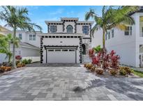 Stunning two-story home with lush landscaping, a paved driveway, and a two-car garage at 534 Estuary Shore Ln, Apollo Beach, FL 33572